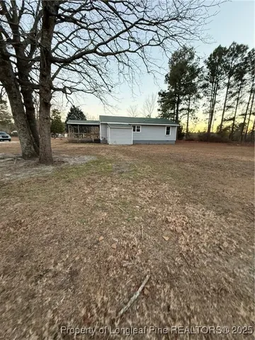 a view of outdoor space with deck and trees