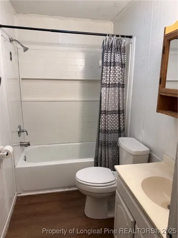a bathroom with a toilet a sink and bathtub