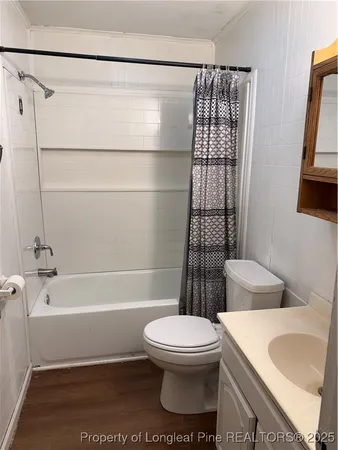 a bathroom with a toilet a sink and bathtub