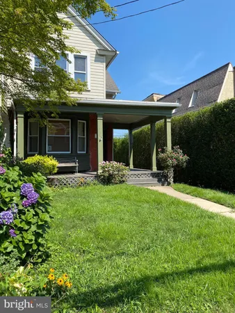 a view of a house with backyard sitting area and garden