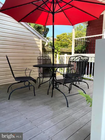 a view of a chairs and table under an umbrella