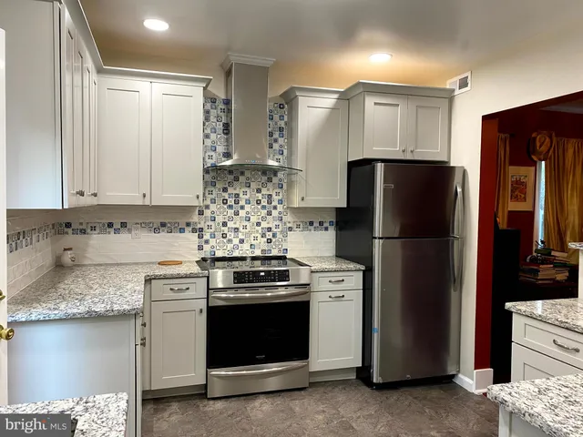 a kitchen with a refrigerator stove and sink
