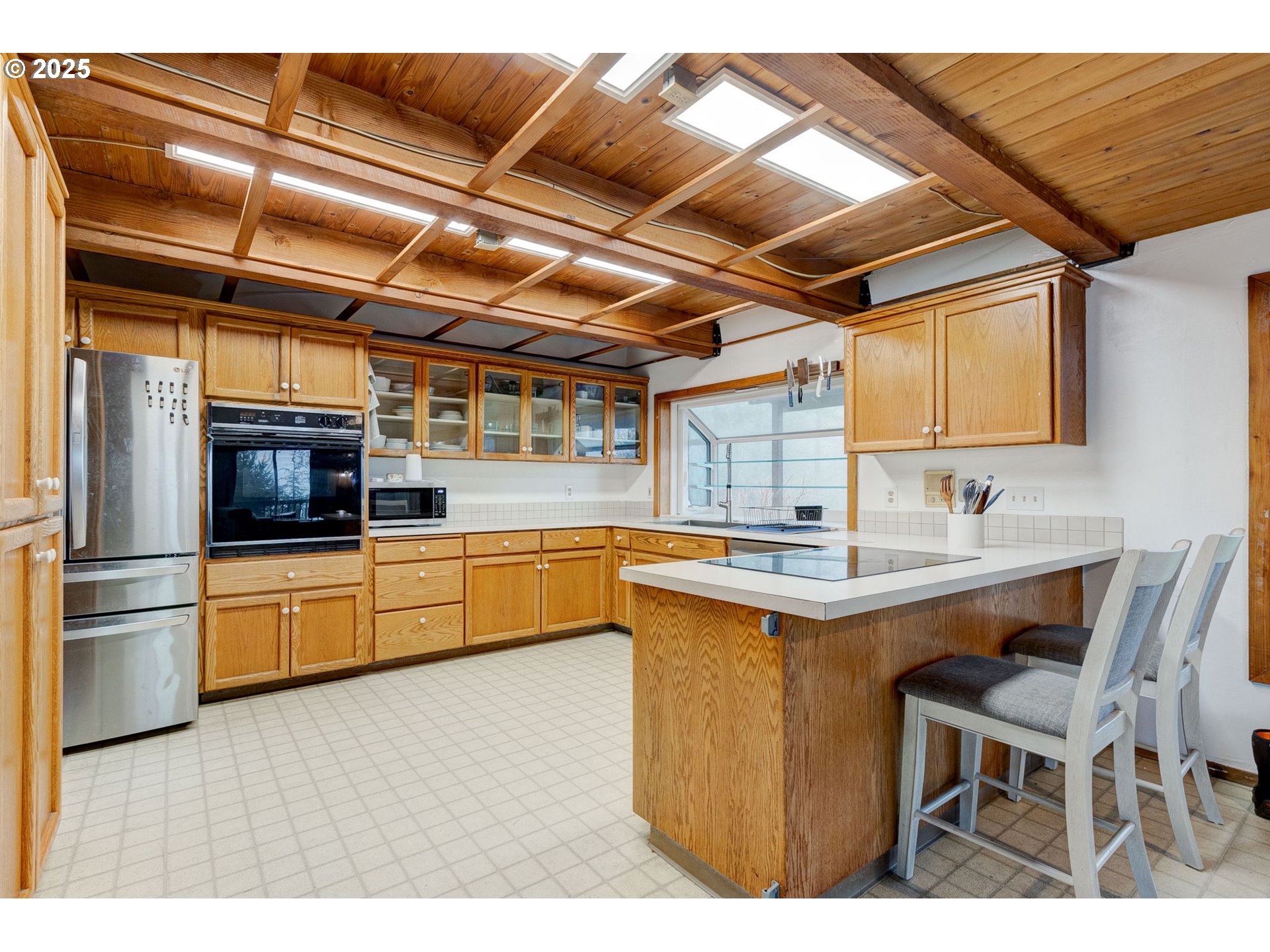 43907 Northeast Columbia Tie Road Amboy, WA 98601 - Photo 10 of 42 a kitchen with stainless steel appliances kitchen island granite countertop a sink cabinets and wooden floor