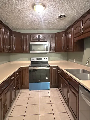 a kitchen with a cabinets and steel stove