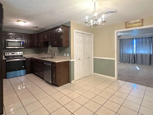 a kitchen with stainless steel appliances granite countertop a sink and cabinets