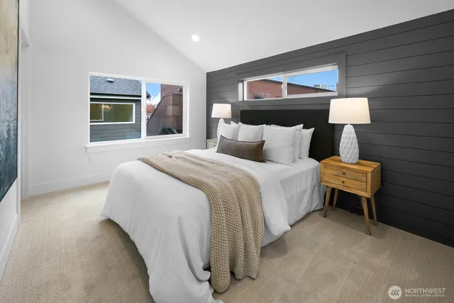 a bed room with a bed and painting on the wall