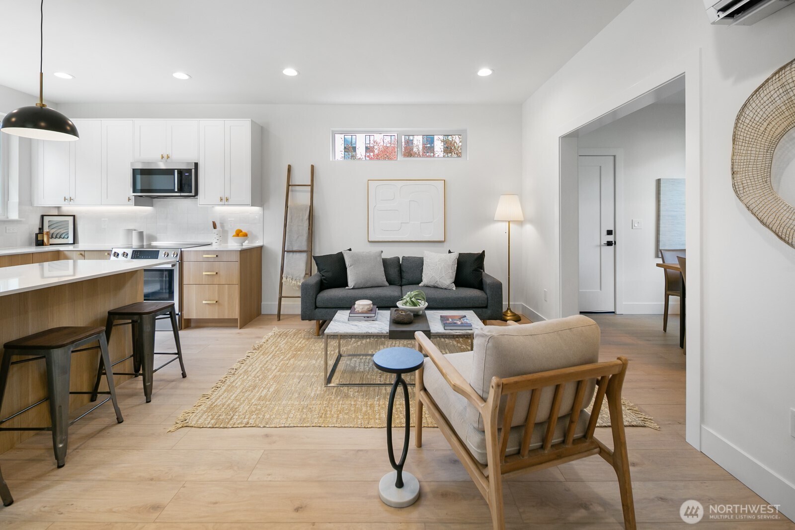 320 North 84th Street Seattle, WA 98103 - Photo 4 of 30 a living room with furniture a rug and kitchen view