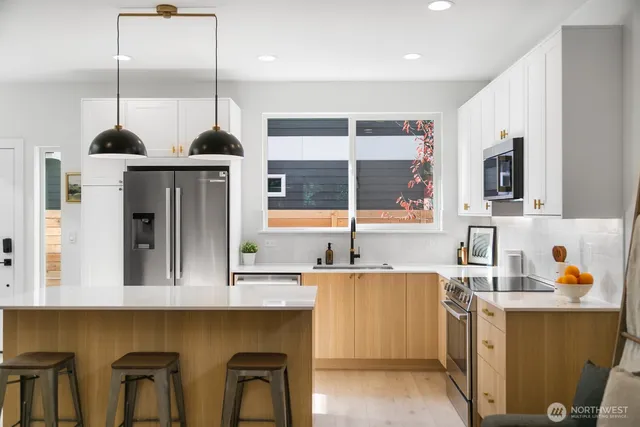 a kitchen with a sink a stove and chairs