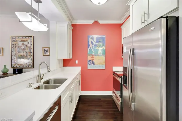 a kitchen with stainless steel appliances granite countertop a refrigerator and a sink