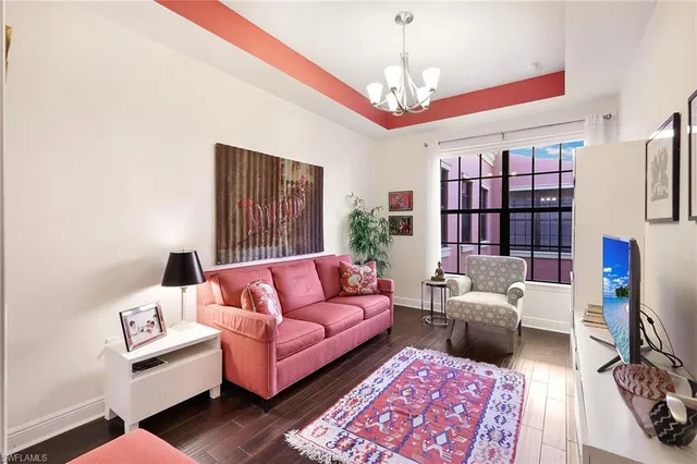 a living room with furniture and a chandelier
