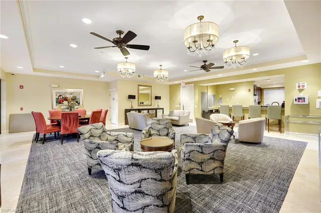 a living room with lots of furniture and chandelier