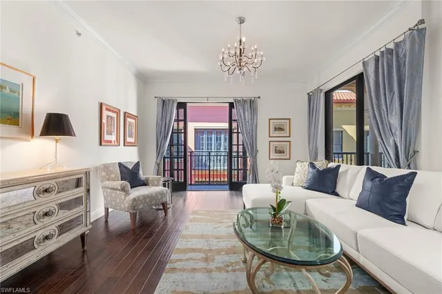 a living room with furniture and a chandelier
