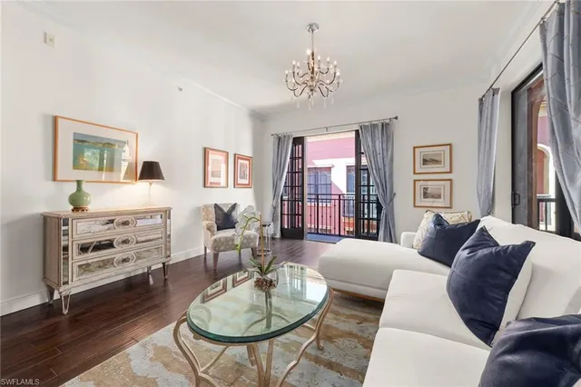 a living room with furniture and a chandelier