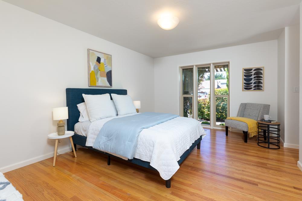 439 Cliff Drive Aptos, CA 95003 - Photo 11 of 29 a bedroom with a bed and wooden floor