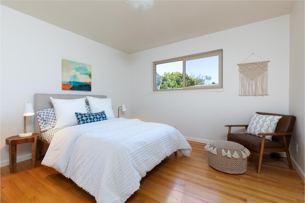 439 Cliff Drive Aptos, CA 95003 - Photo 14 of 29 a bedroom with a bed and wooden floor