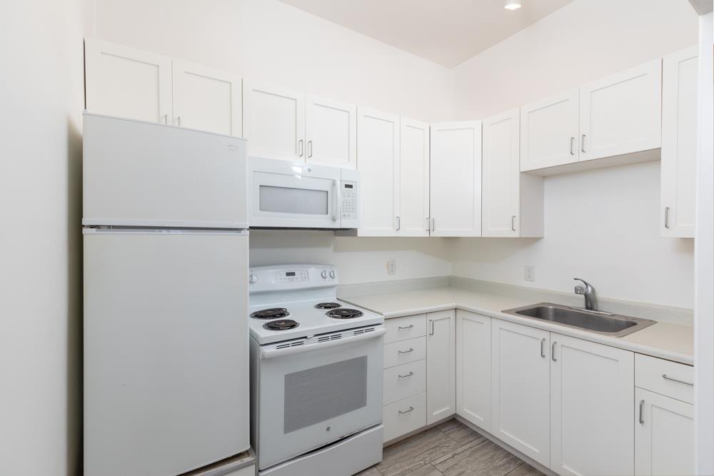439 Cliff Drive Aptos, CA 95003 - Photo 24 of 29 a white kitchen with sink and white stainless steel appliances