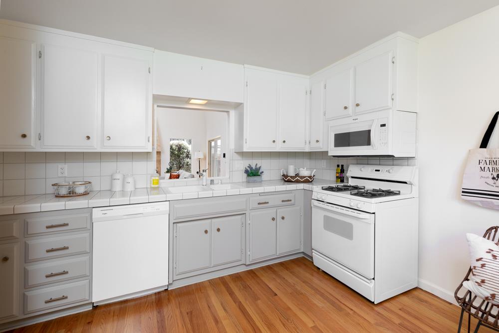 439 Cliff Drive Aptos, CA 95003 - Photo 9 of 29 a kitchen with cabinets stainless steel appliances a sink and wooden floor