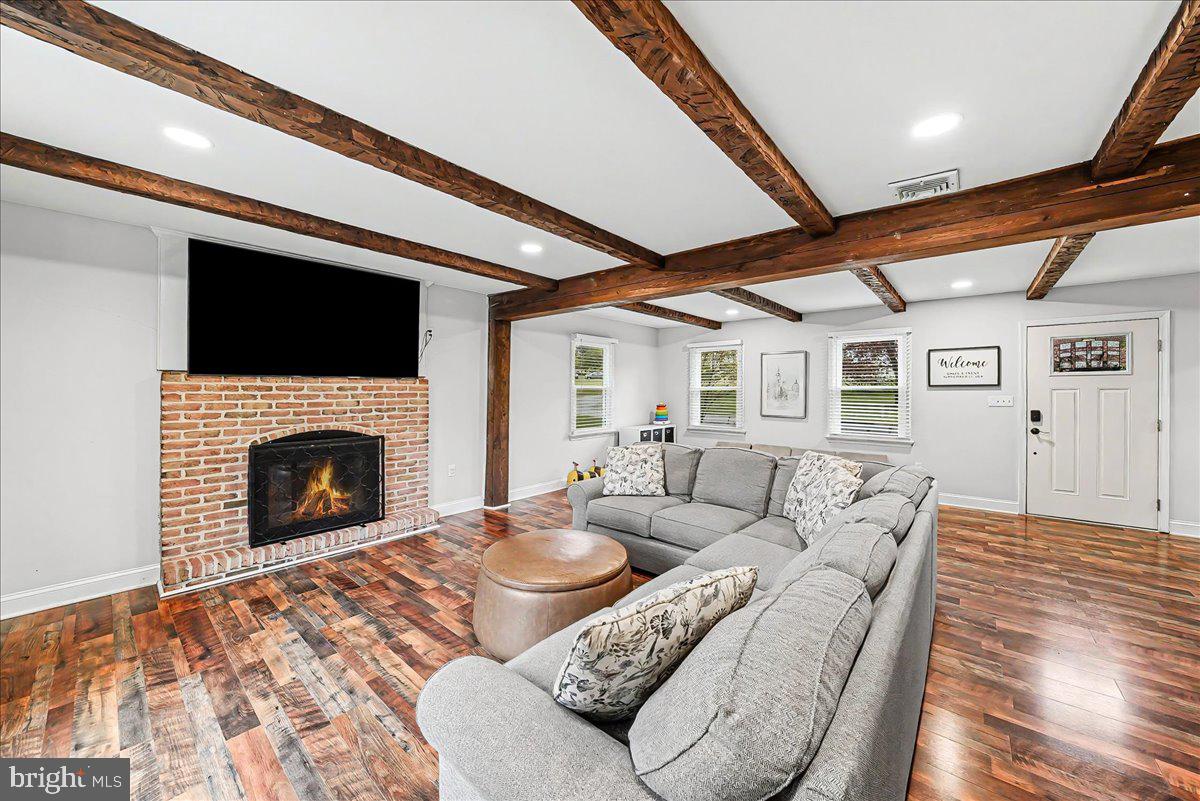 772 Hunters Run Road Pottstown, PA 19465 - Photo 13 of 44 a living room with furniture a fireplace and a flat screen tv