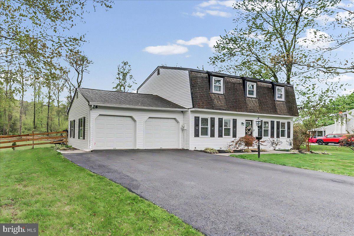 772 Hunters Run Road Pottstown, PA 19465 - Photo 2 of 44 a front view of a house with a garden and trees