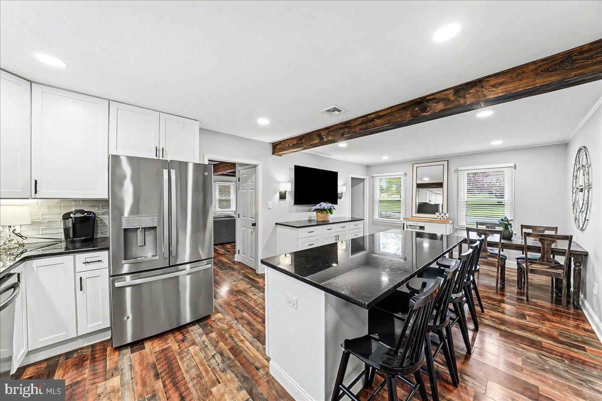 772 Hunters Run Road Pottstown, PA 19465 - Photo 21 of 44 a kitchen with stainless steel appliances a dining table chairs and refrigerator