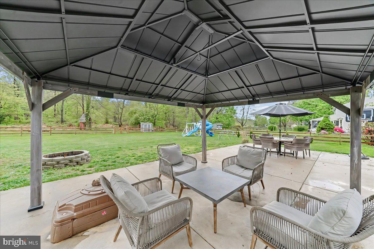 772 Hunters Run Road Pottstown, PA 19465 - Photo 4 of 44 a view of patio with table and chairs under an umbrella