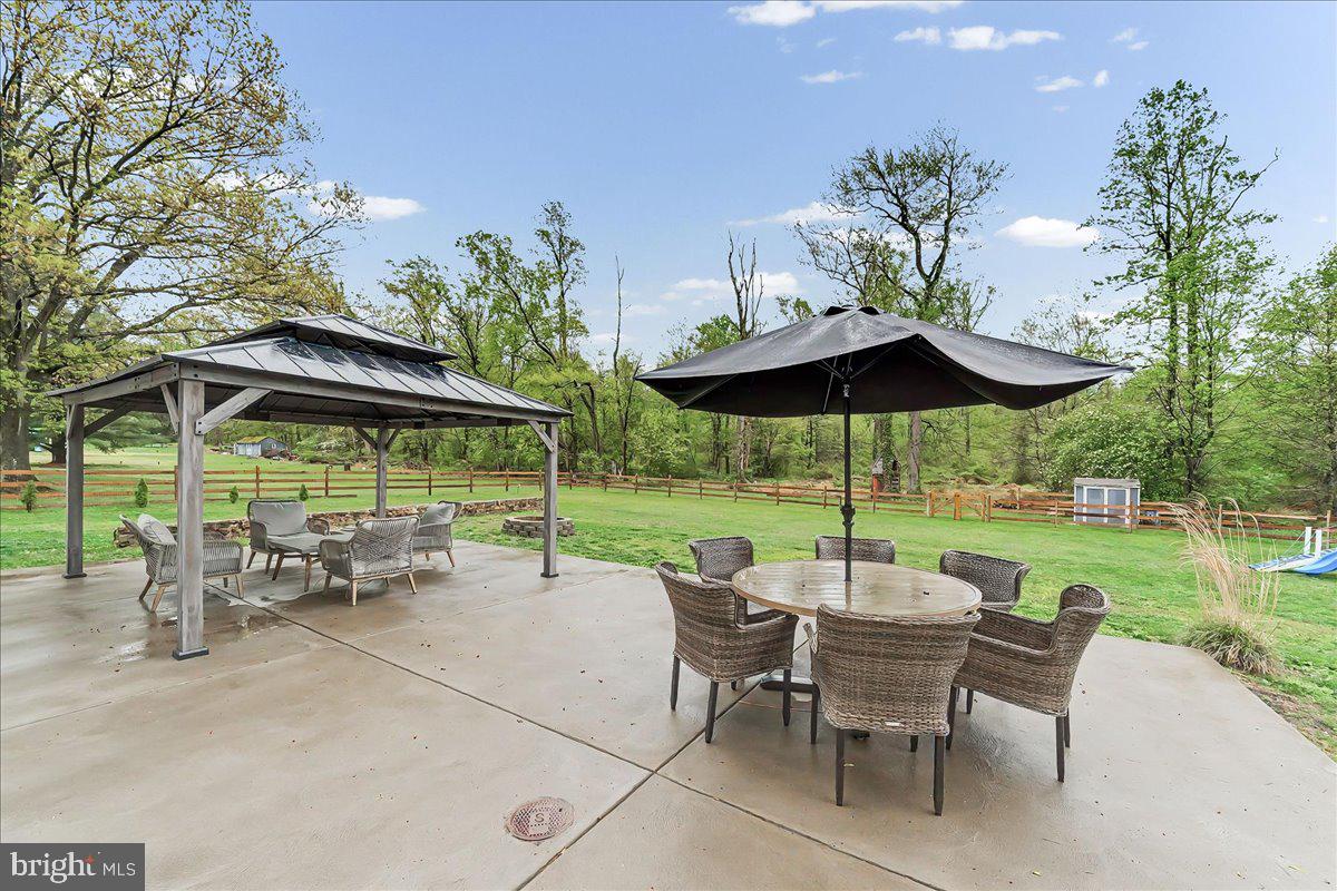 772 Hunters Run Road Pottstown, PA 19465 - Photo 5 of 44 an outdoor space with furniture and umbrella