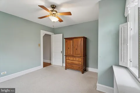 a view of an empty room with a ceiling fan