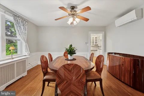 a dining room with furniture a window and wooden floor