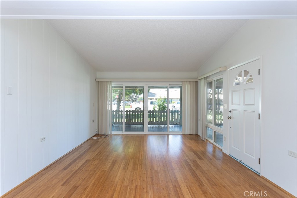 1180 Oakmont Road, Unit 51H Seal Beach, CA 90740 - Photo 15 of 31 wooden floor in an empty room with a window