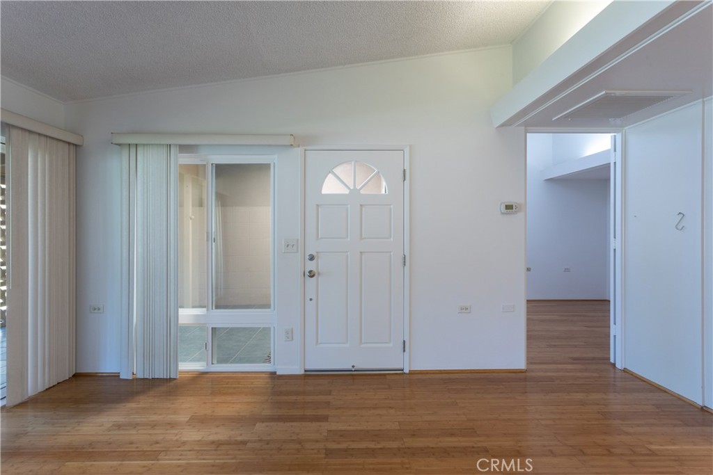 1180 Oakmont Road, Unit 51H Seal Beach, CA 90740 - Photo 16 of 31 a view of an empty room with wooden floor and a bathroom