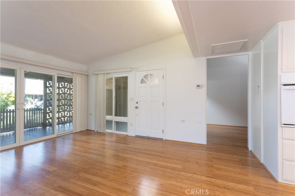 1180 Oakmont Road, Unit 51H Seal Beach, CA 90740 - Photo 17 of 31 wooden floor in an empty room with a window