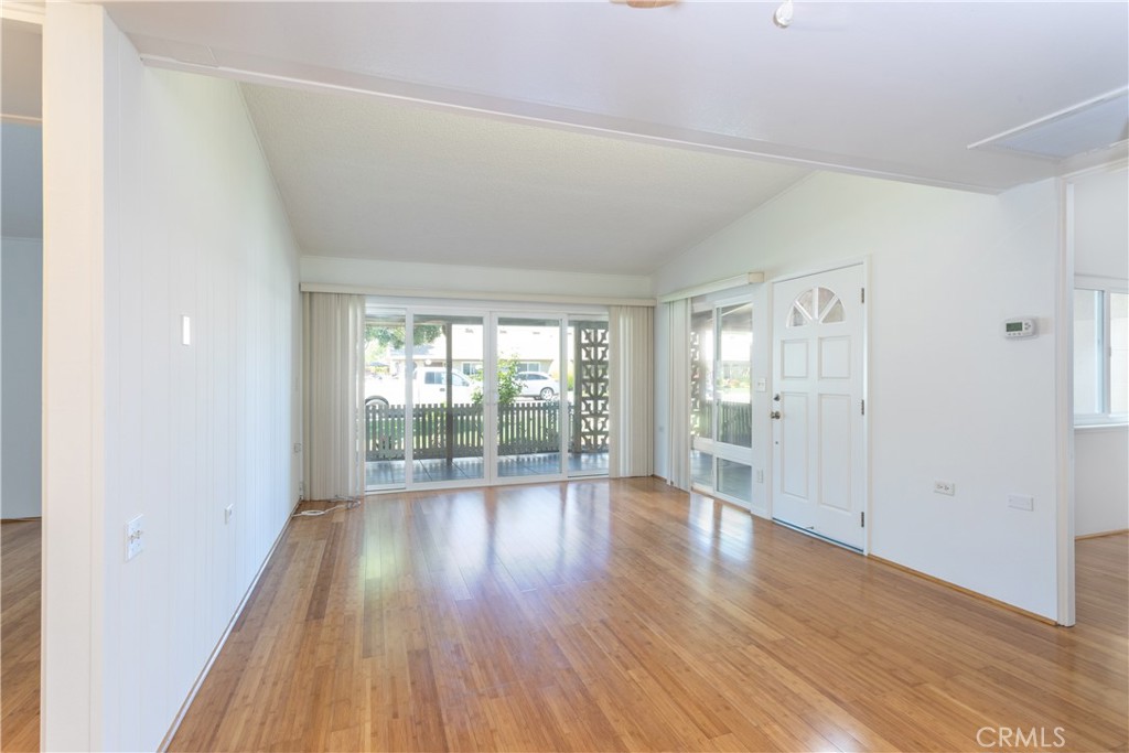 1180 Oakmont Road, Unit 51H Seal Beach, CA 90740 - Photo 18 of 31 wooden floor in an empty room with a window
