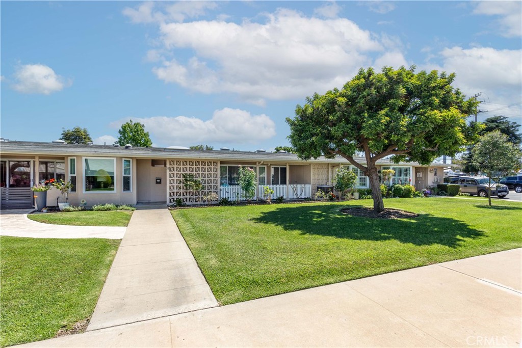 1180 Oakmont Road, Unit 51H Seal Beach, CA 90740 - Photo 2 of 31 a front view of a house with a yard table and chairs