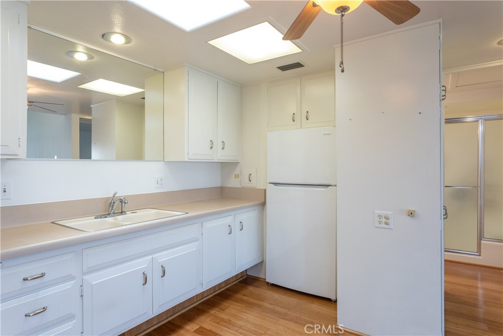 1180 Oakmont Road, Unit 51H Seal Beach, CA 90740 - Photo 21 of 31 a bathroom with a sink and a mirror