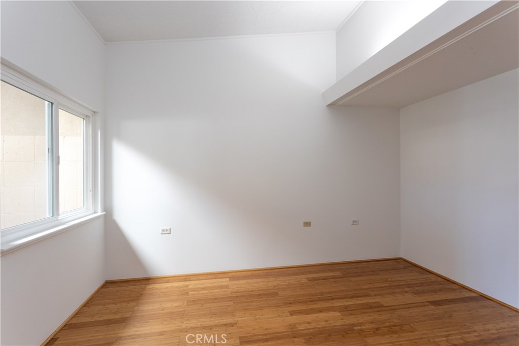 1180 Oakmont Road, Unit 51H Seal Beach, CA 90740 - Photo 22 of 31 wooden floor in an empty room with a window