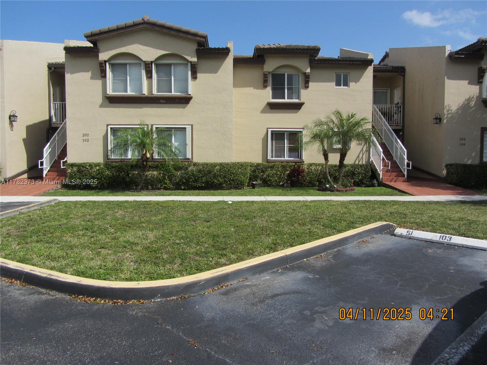 Villa Encantada Miami, FL 33177 - Photo 4 of 35 a front view of a house with a yard