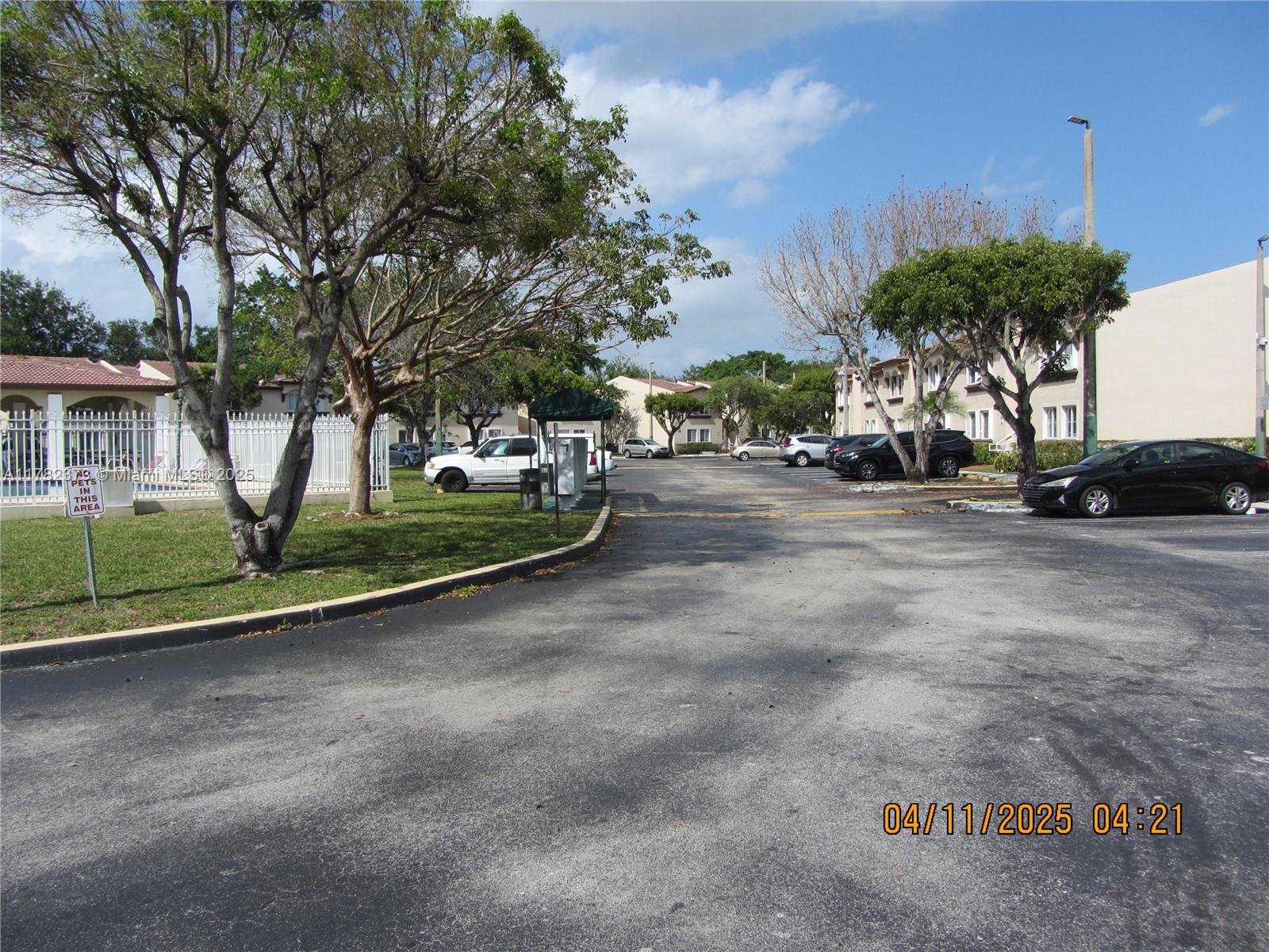 Villa Encantada Miami, FL 33177 - Photo 5 of 35 a view of a street with a cars park side of a road