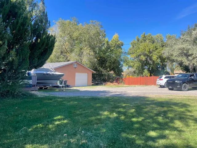 a front view of a house with a yard and potted plants