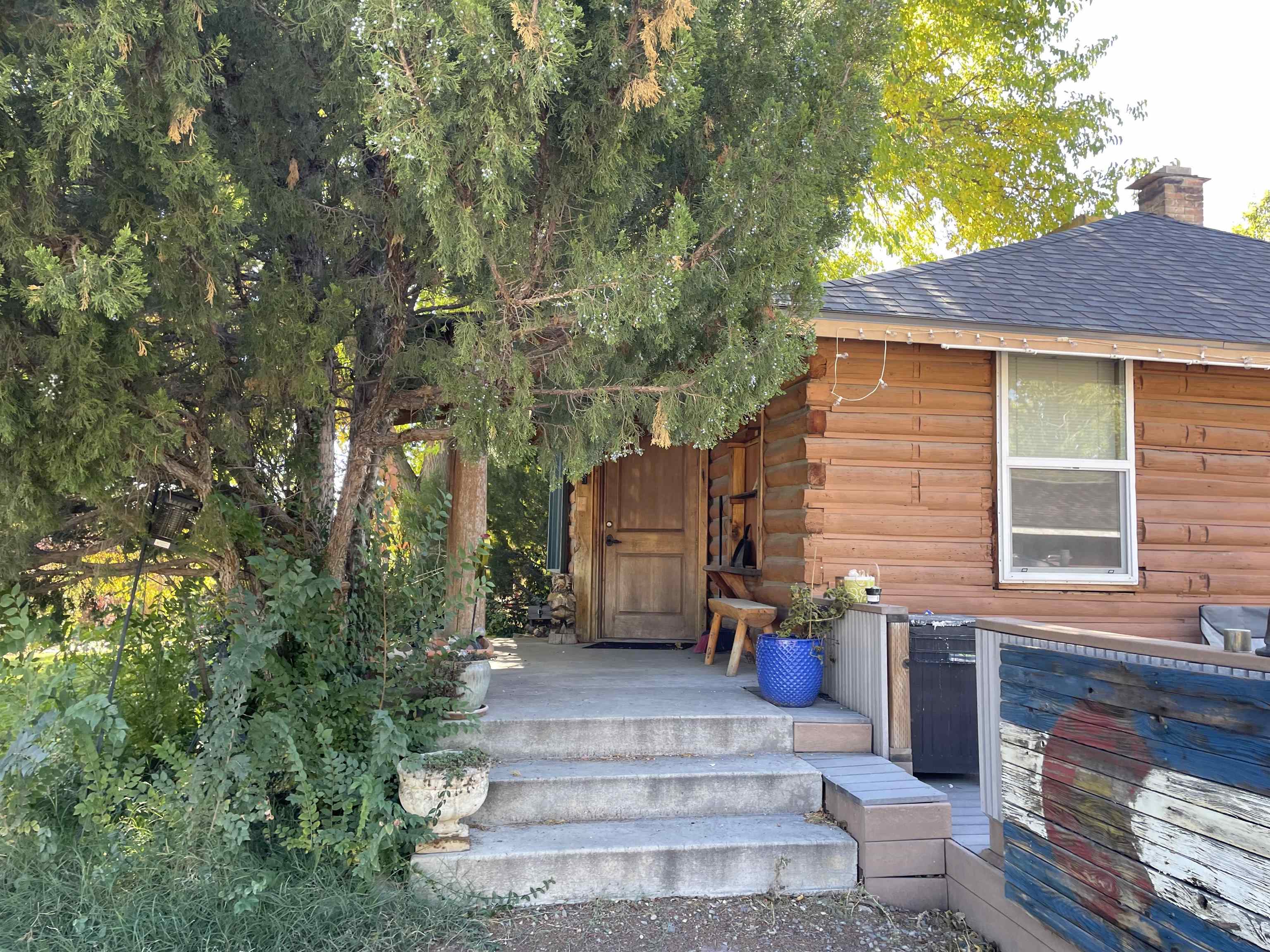 751-26 26 1/2 Road Grand Junction, CO 81506 - Photo 6 of 10 a front view of a house with a yard and potted plants