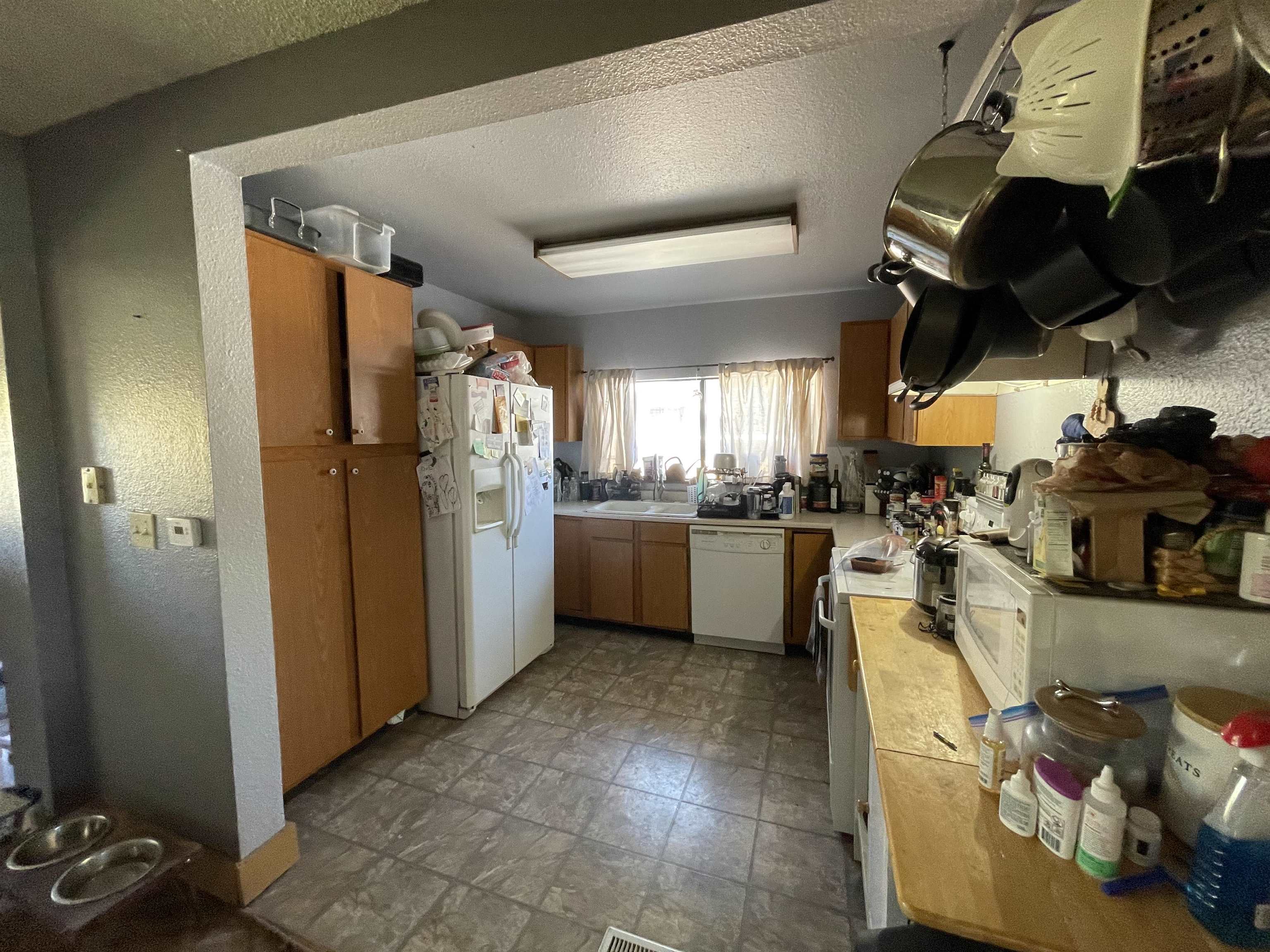 751-26 26 1/2 Road Grand Junction, CO 81506 - Photo 7 of 10 a kitchen with stainless steel appliances granite countertop a refrigerator a sink a stove and white cabinets