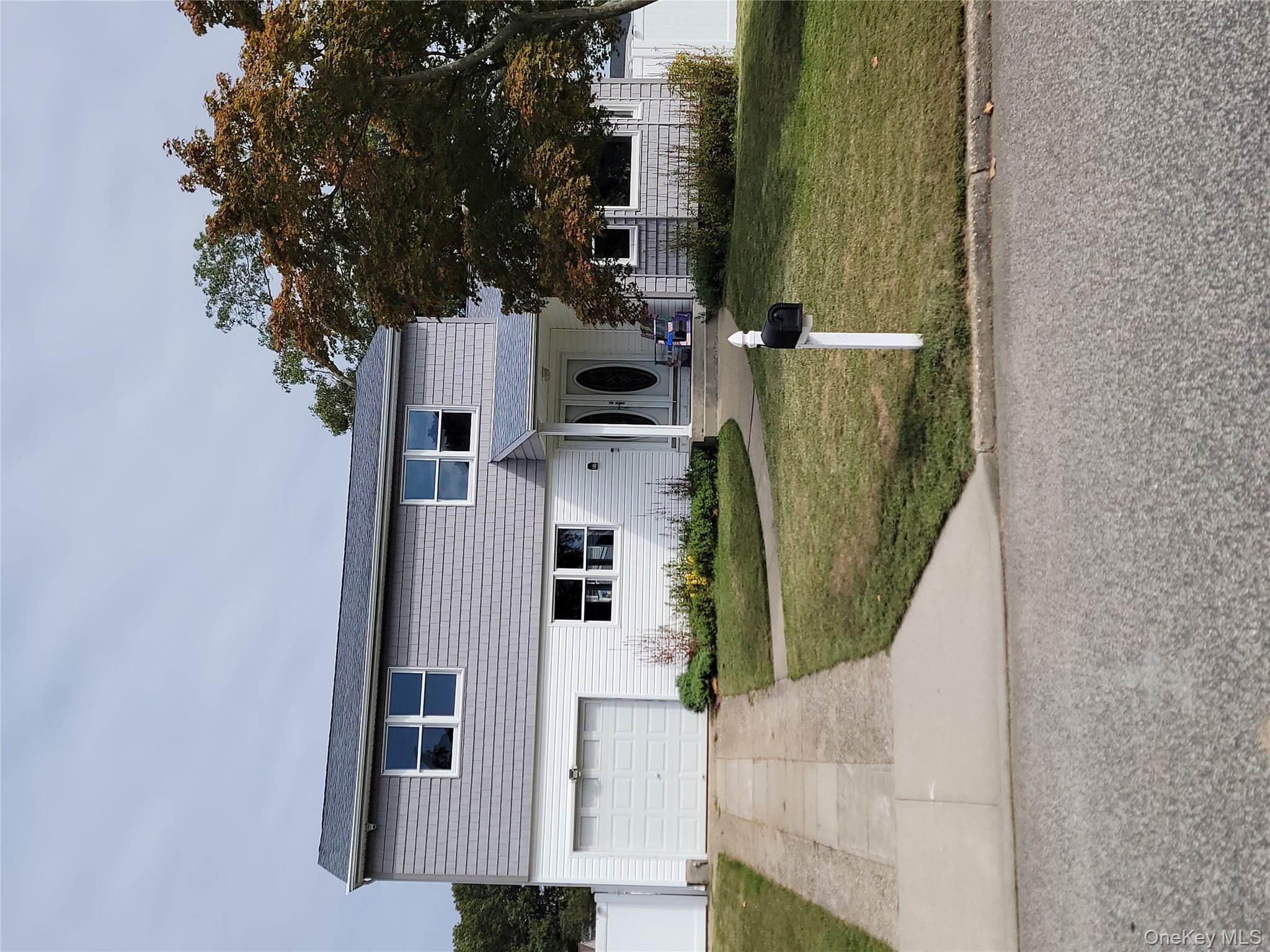 7 Deville Drive Selden, NY 11784 - Photo 1 of 19 a front view of a house with a yard