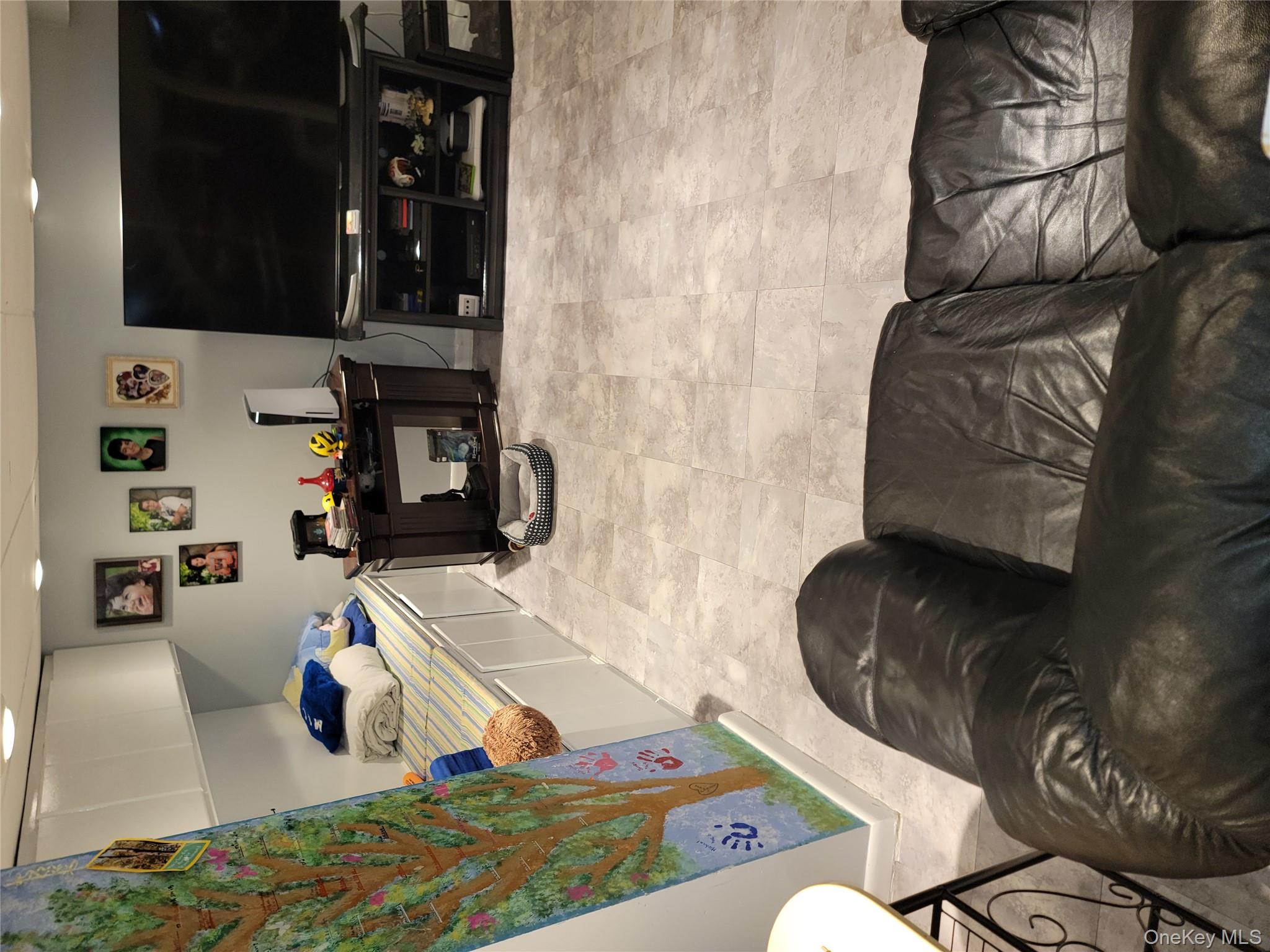 7 Deville Drive Selden, NY 11784 - Photo 13 of 19 a living room with furniture and a flat screen tv