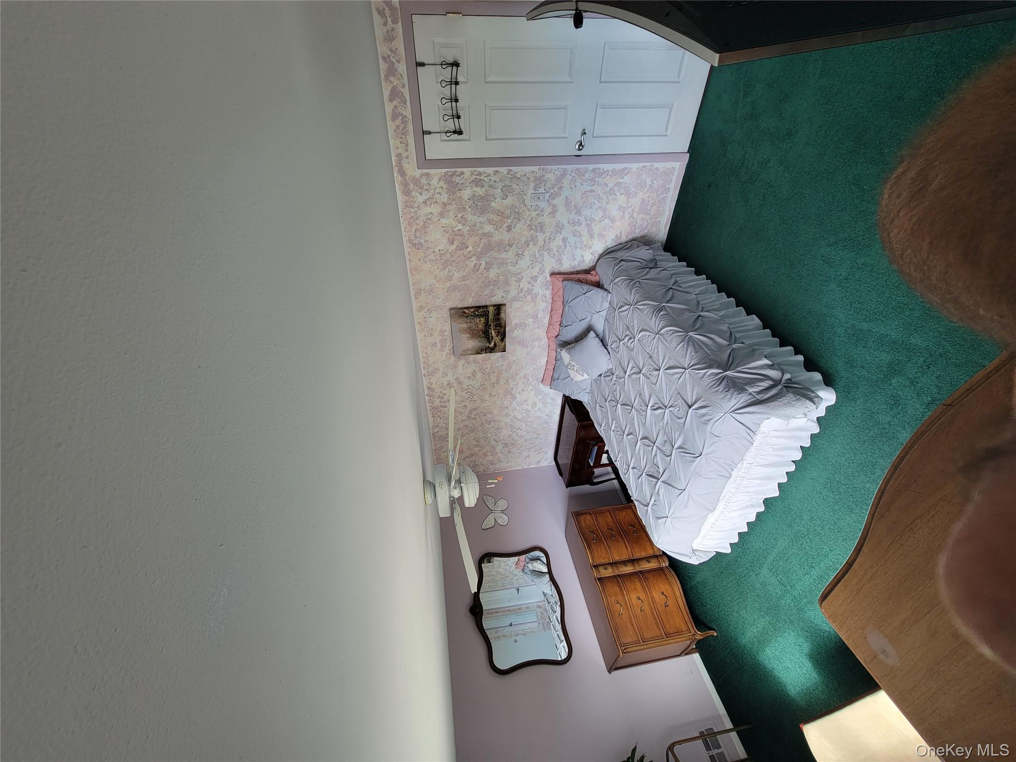 7 Deville Drive Selden, NY 11784 - Photo 14 of 19 a bedroom with a bed and a closet