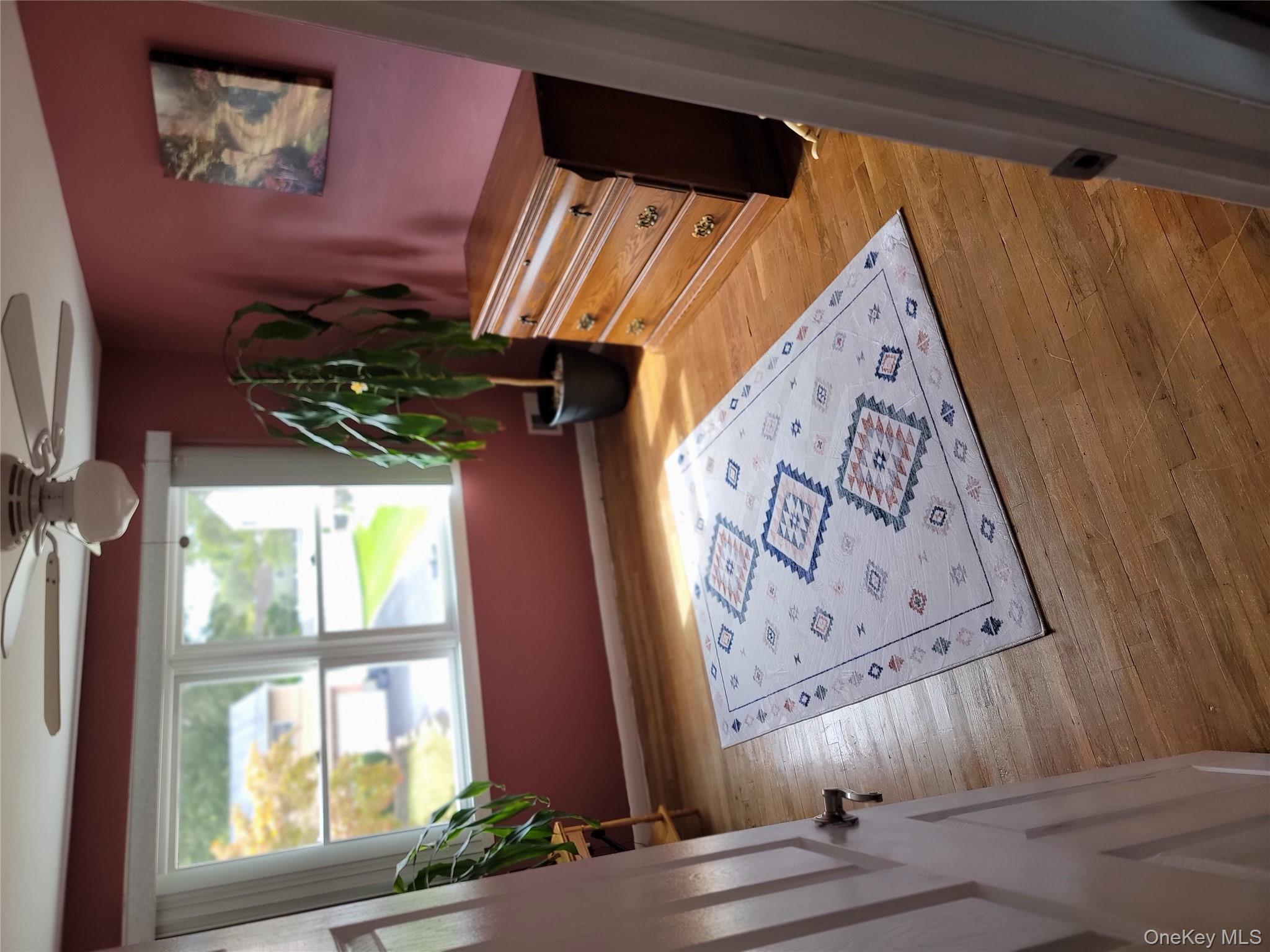 7 Deville Drive Selden, NY 11784 - Photo 15 of 19 a view of a bedroom with wooden floor and a potted plant