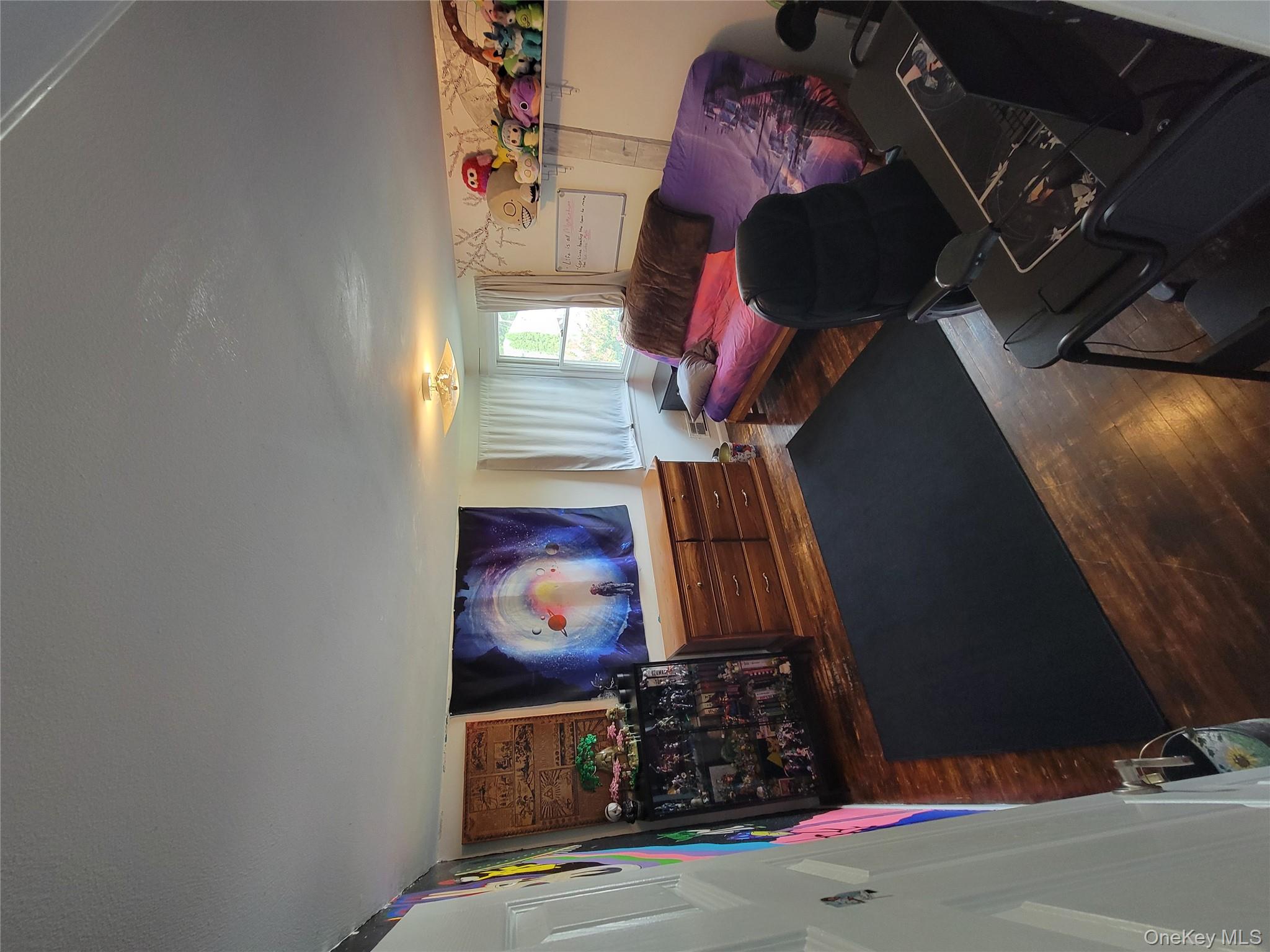 7 Deville Drive Selden, NY 11784 - Photo 17 of 19 a bedroom with furniture and a flat screen tv