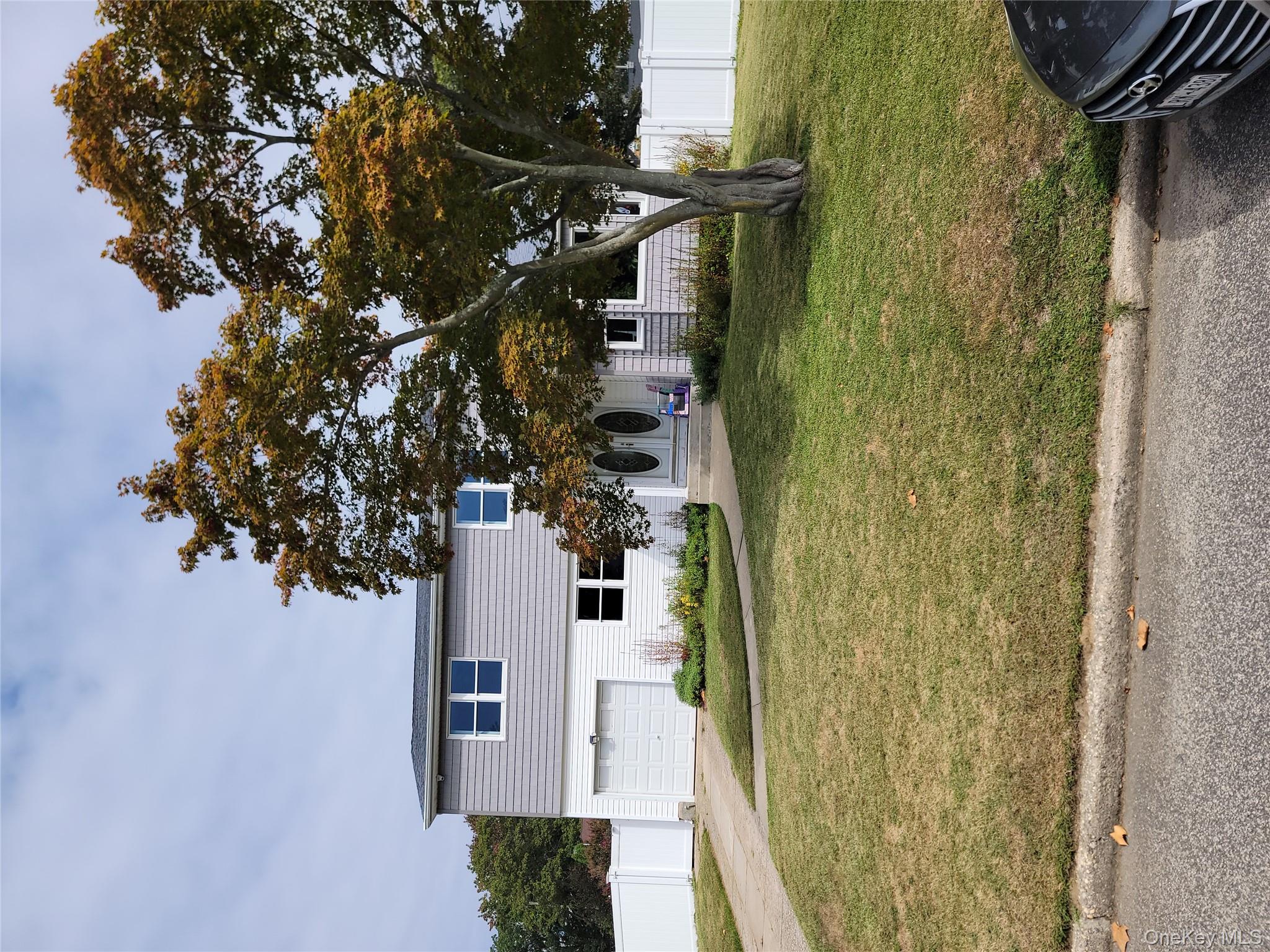 7 Deville Drive Selden, NY 11784 - Photo 2 of 19 a house view with a swimming pool in front of it