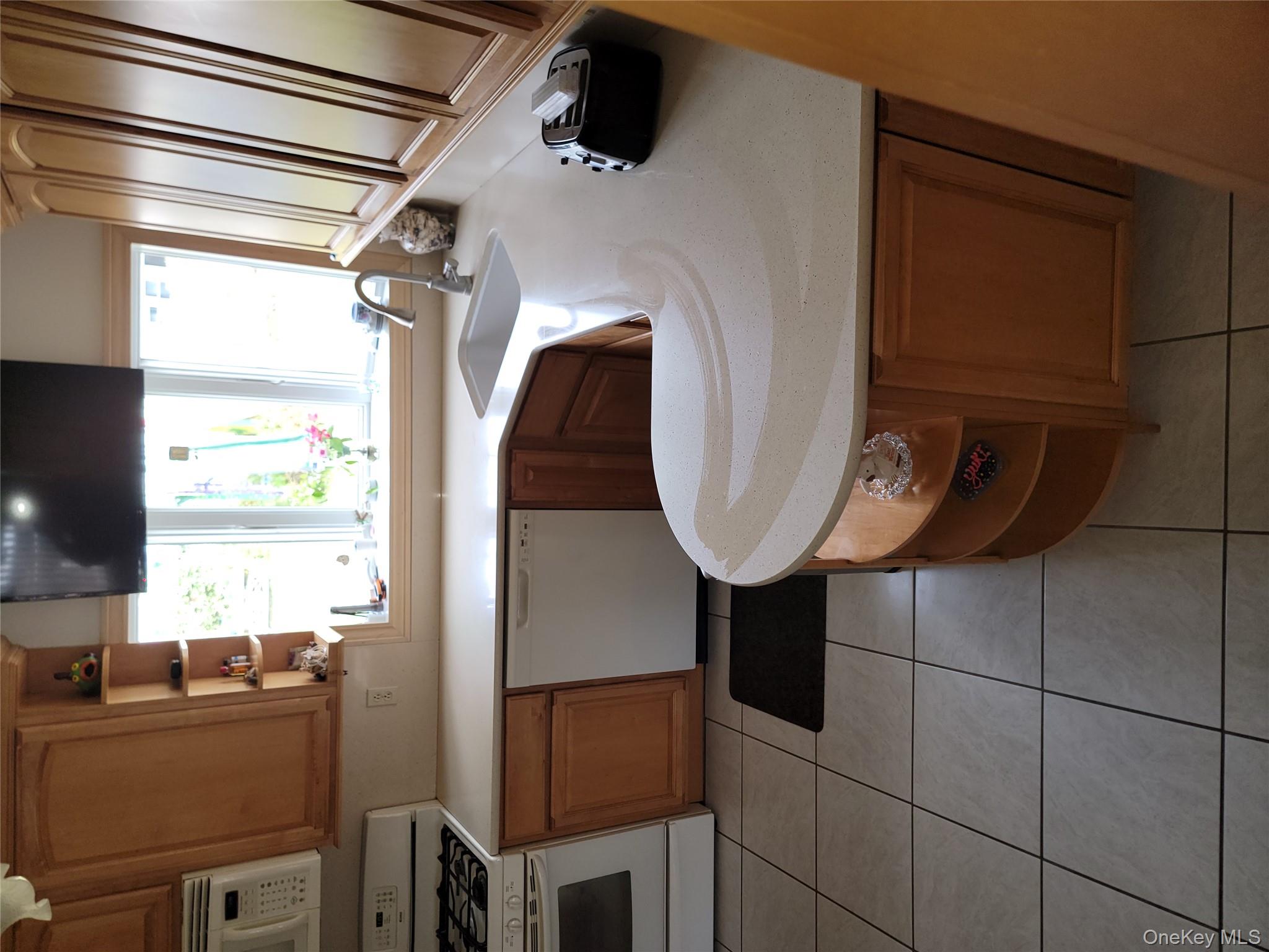 7 Deville Drive Selden, NY 11784 - Photo 8 of 19 a kitchen with a sink and a stove top oven