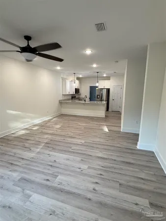 a view of a kitchen with a sink and wooden floor