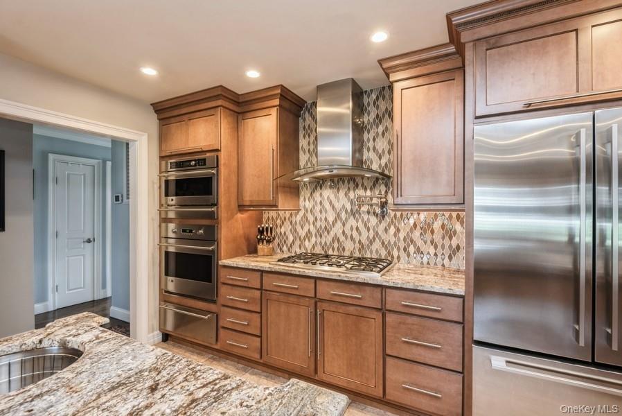 330 Private Road East Patchogue, NY 11772 - Photo 20 of 42 a kitchen with stainless steel appliances kitchen island granite countertop a refrigerator and a stove top oven