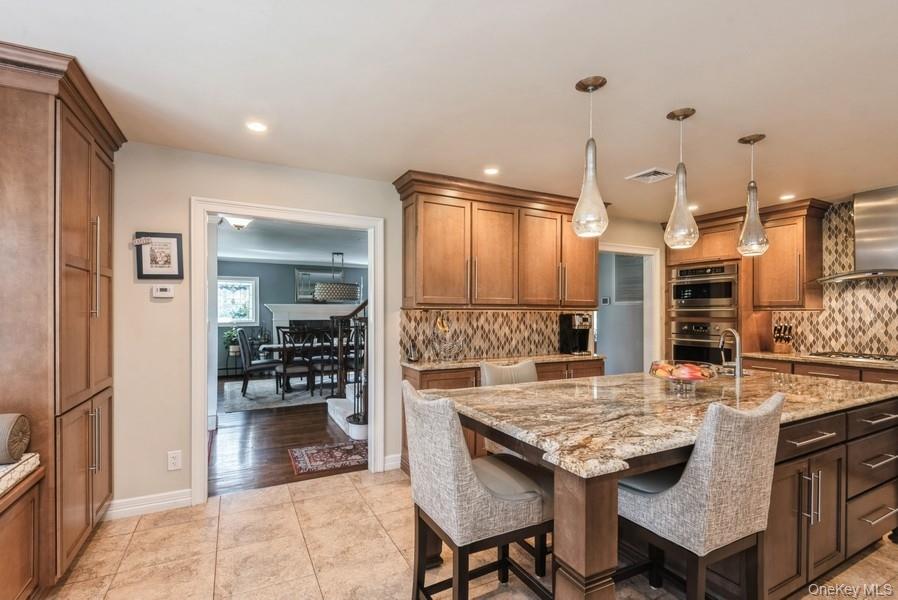 330 Private Road East Patchogue, NY 11772 - Photo 22 of 42 a open kitchen with granite countertop a stove and a sink